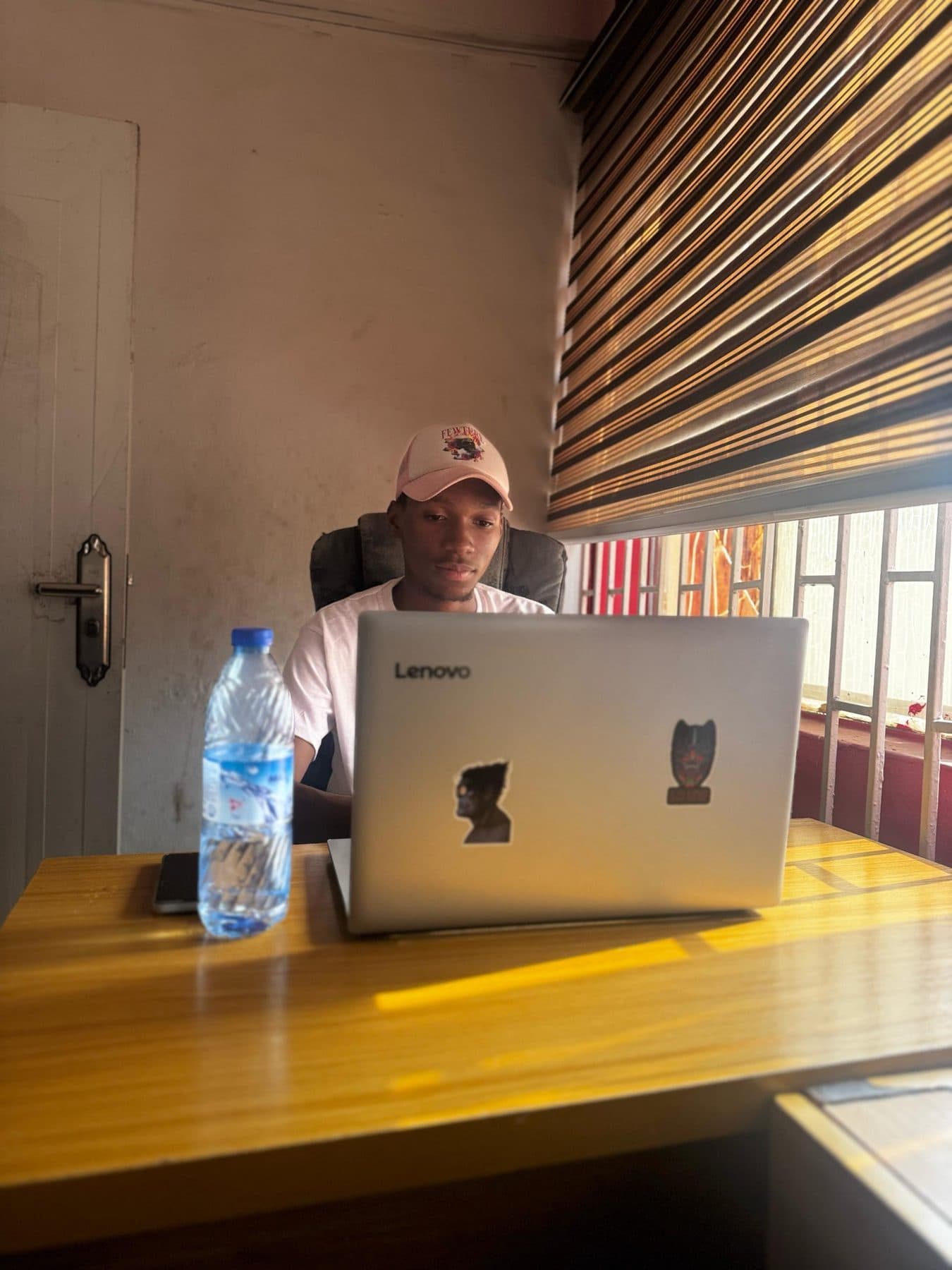 A student working at a laptop on campus