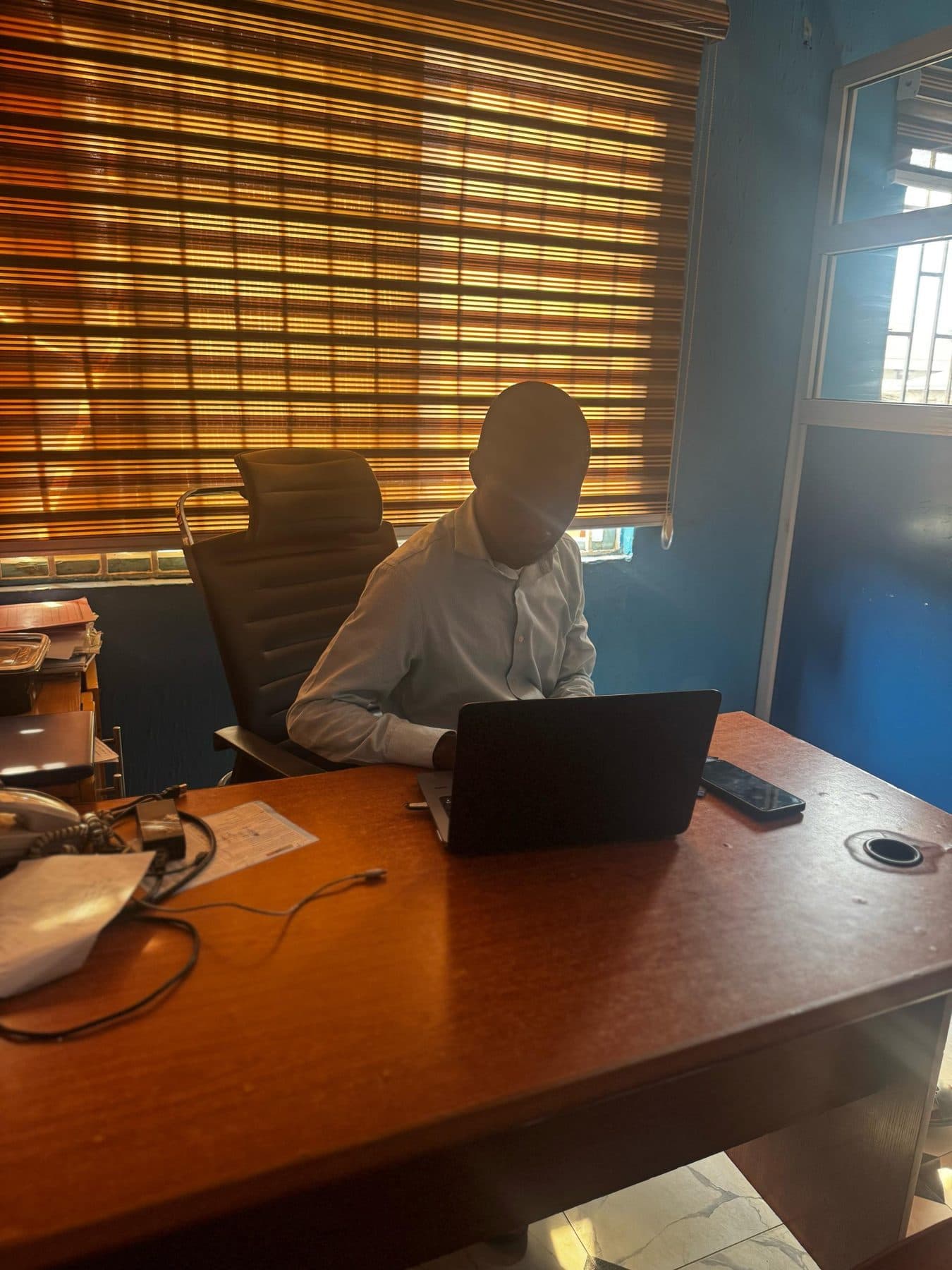 A staff member working at a desk in the campus office